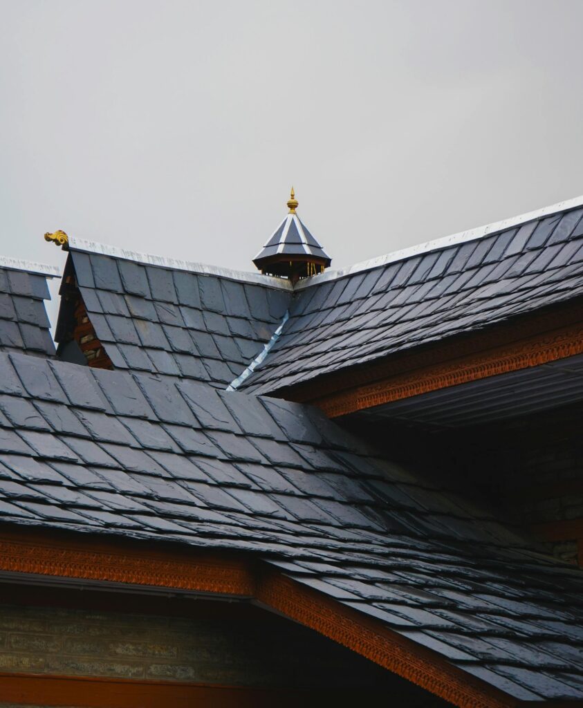 Close-up of a traditional architectural roof showcasing detailed shingles and ornamentation.